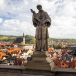 Statue auf der Mantelbrücke, dahinter die Altstadt