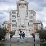 Das Denkmal des spanischen Nationaldichters Miguel de Cervantes auf dem Plaza de España in Madrid, dahinter das Hochhaus Edificio España