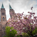 Außenansicht der Sebalduskirche mit Kirschblüten davor