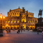 Außenansicht der Dresdner Semperoper mit dem König-Johann-Denkmal während der blauen Stunde