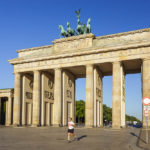 Ein Jogger vor dem Brandenburger Tor kurz nach Sonnenaufgang in Berlin