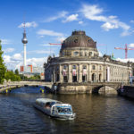 Ein Boot auf der Spree vor dem Bode-Museum und dem Fernsehturm in Berlin